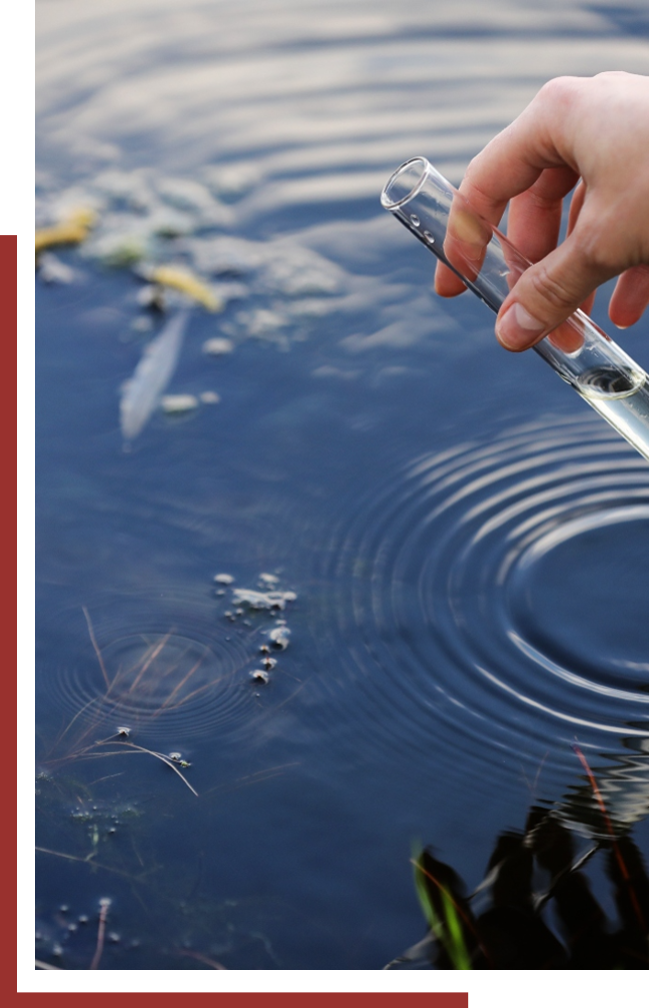 Man testing creek water with a tube