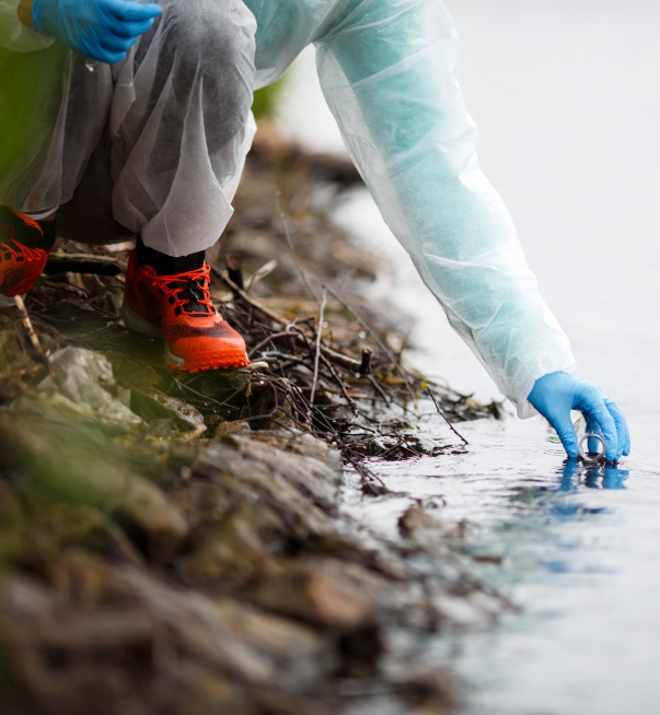 person testing water from a river